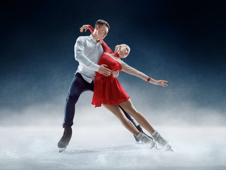 Professional man and woman figure skaters performing show or competition on ice arena