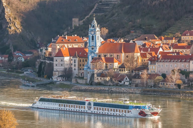 Durnstein village during spring time with tourist ship on Danube river in Wachau (UNESCO), Austria