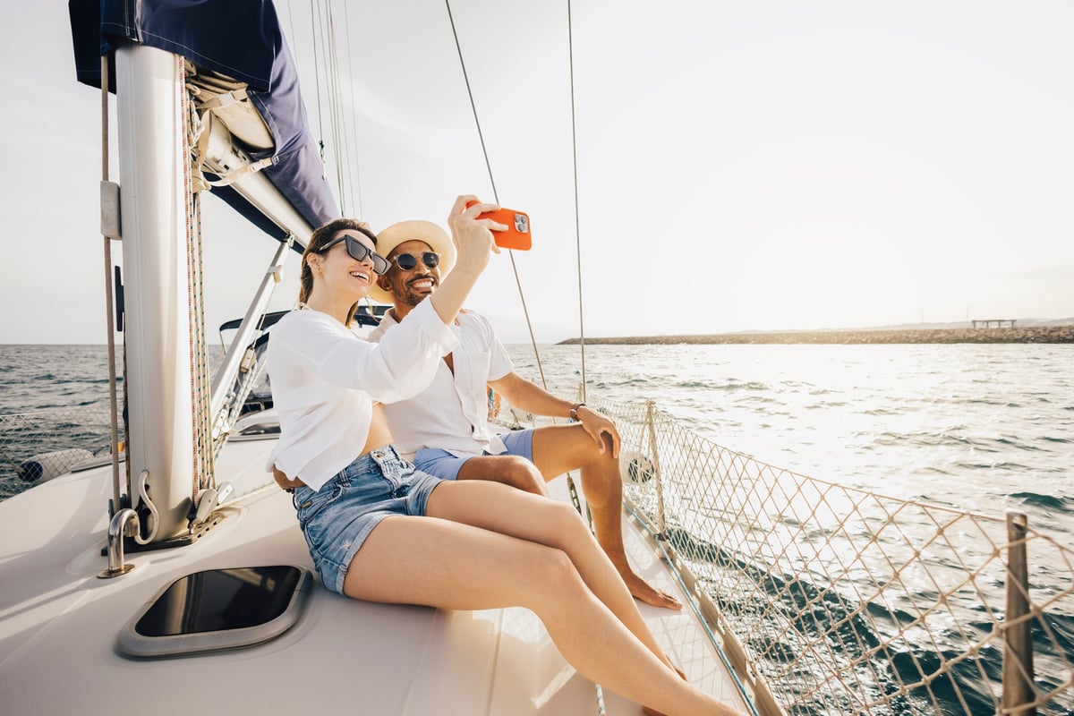 Happy couple enjoying a relaxing day on a sailboat