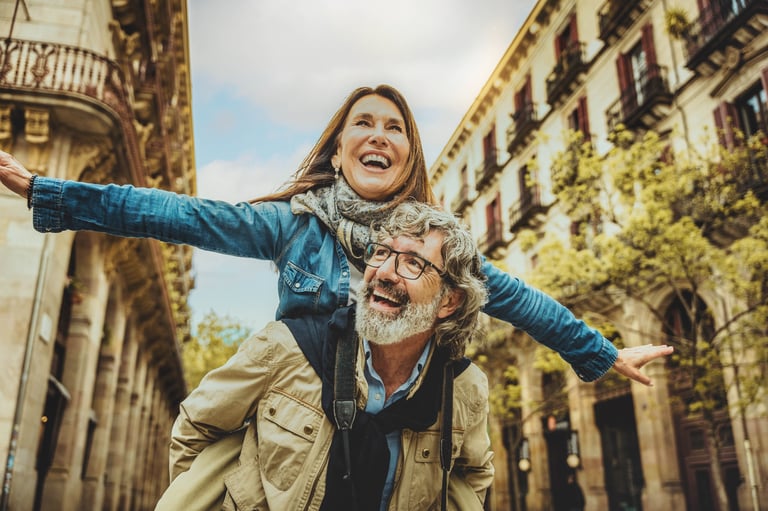 Happy senior couple having fun walking on city street